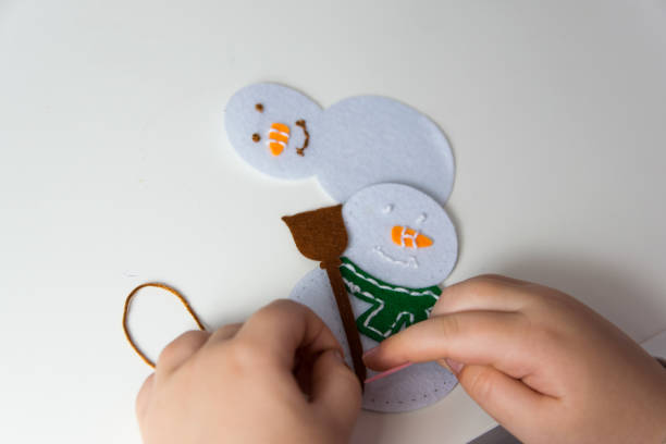 istock Child make snowmans for christmas. 1755967367
