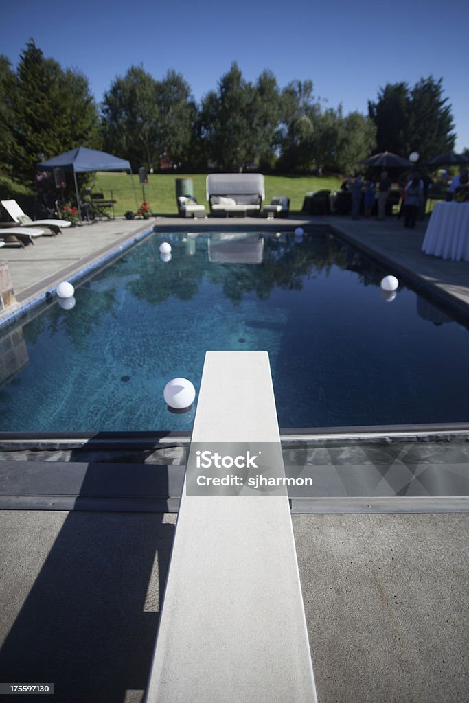 Summer Cool Blue Water Swimming Pool Relaxation Family Vacation Diving board view of a cool summer pool at a hotel or summer vacation location Architecture Stock Photo