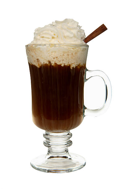 Cocktails on white: Irish Coffee. A warm Irish Coffee topped with wipped cream and a cinnamon stick. coffee liqueur stock pictures, royalty-free photos & images