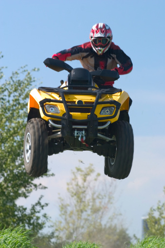 All terrain vehicle jumping in air. We have other extreme atv and motorcross shots in our portfolio.