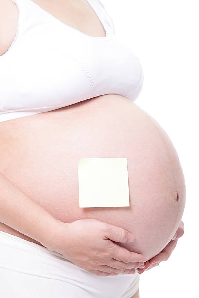 istock pregnant woman with notepaper on her belly 175597776