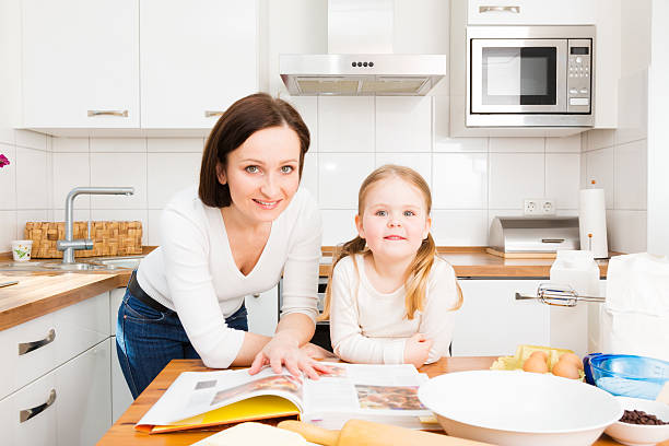 istock mother and daughter baking cookies 175597921