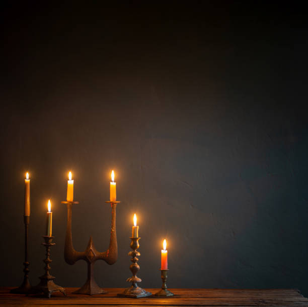 istock burning candles in vintage candlesticks on dark background 1755980204