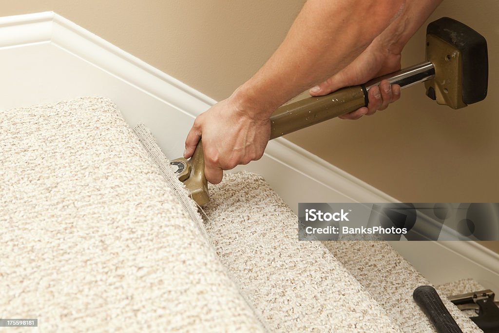 Installer Using Carpet Stretcher On Stairs Stock Photo - Download Image Now  - Carpet - Decor, Installing, Staircase - iStock