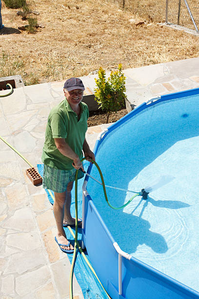 istock Man cleaning swimming pool 175598393