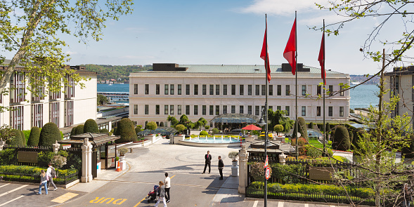 Istanbul, Turkey - May 8, 2023: Morning view from Ciragan street of modern architectural design five stars Four Seasons hotel by Bosphorus Strait, at Besiktas district, in a sunny spring day