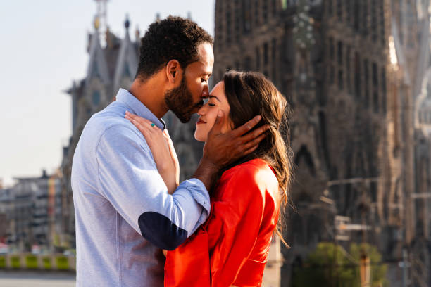 Multiracial beautiful happy couple of lovers dating in Barcelona stock photo