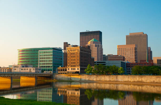 Dayton skyline at dawn "Downtown Dayton, OH skyline at dawn / early morning, with Mad River in the foreground." dayton ohio skyline stock pictures, royalty-free photos & images