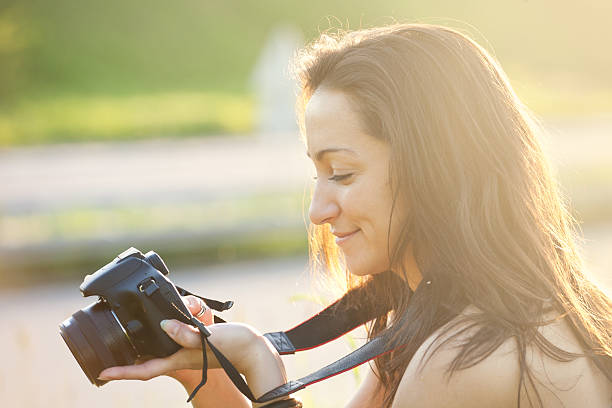 istock Smiling woman photographer with camera 175599652
