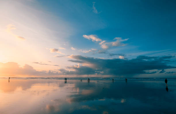 istock Poeple on the beach at sunset 1755999996