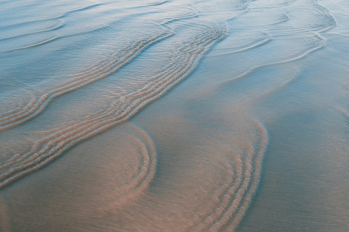 Rippled waves on a beach created by the moving tide and shifting sands, Devon UK