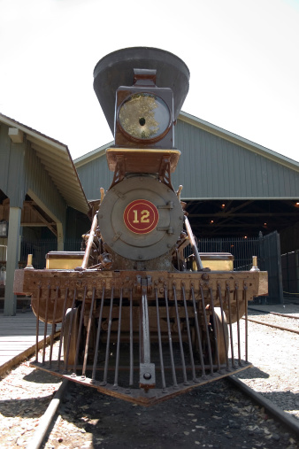 Front of a vintage steam train engine.