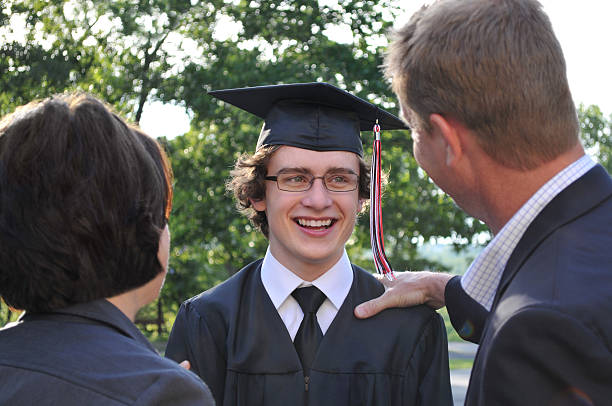 istock Excited High School Graduate Standing with his Parents 175600513