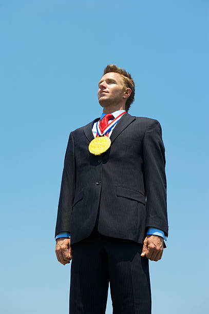 istock Gold Medal Businessman Stands in Blue Sky 175601434