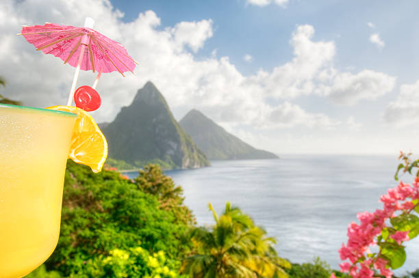 Enjoying a tropical cocktail and the view of St. Lucia's Twin Pitons.