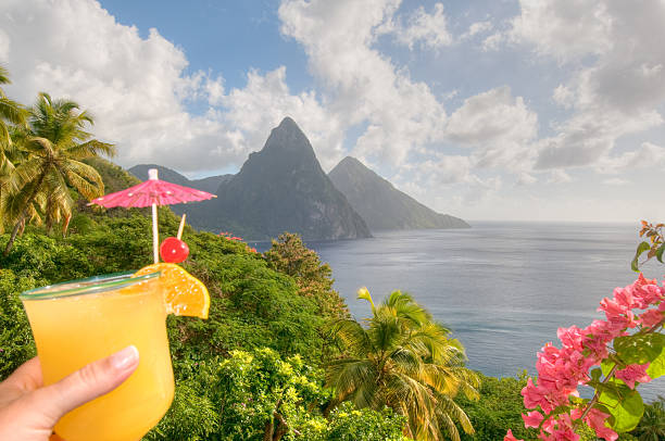 St. Lucia's Twin Pitons and tropical cocktail stock photo