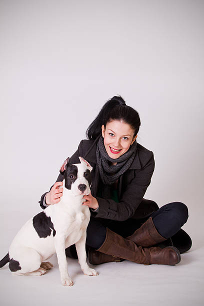 istock Young woman with pitbull puppy 175601578