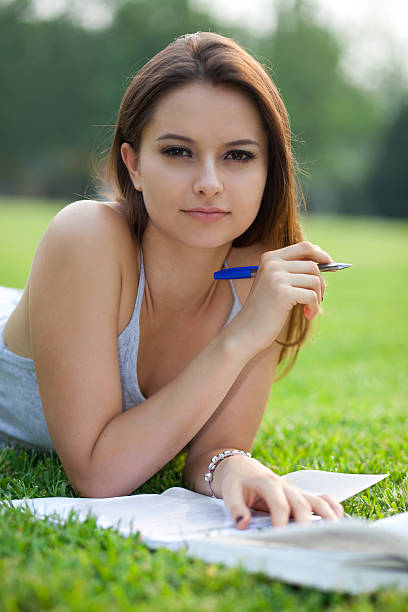 istock beautiful student with book in park 175601900