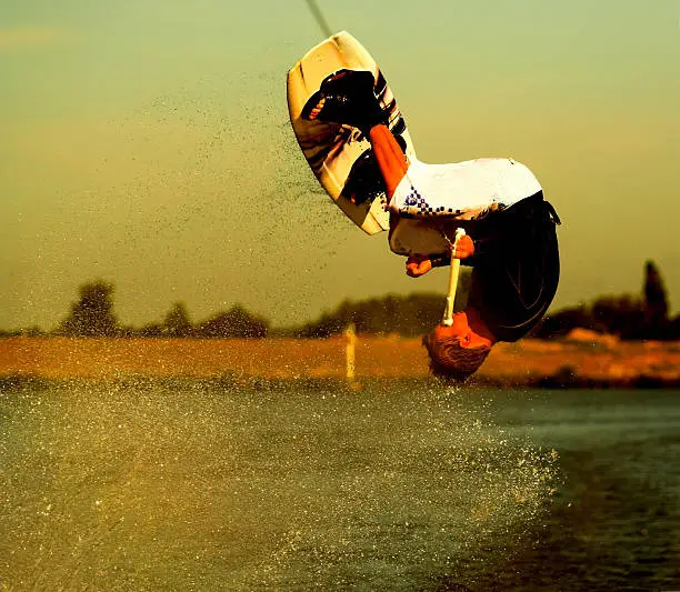 Wakeboarder upside down during a frontroll. Strange colors are on purpose.