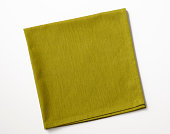 Isolated shot of folded green napkin on white background