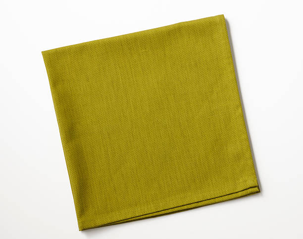 Isolated shot of folded green napkin on white background Folded green napkin isolated on white background with clipping path. handkerchief photos stock pictures, royalty-free photos & images