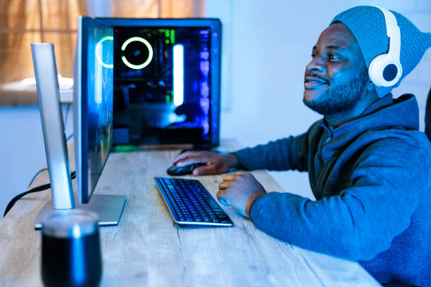istock Black Gamer Playing Online Video Game on Personal Computer 1756023323