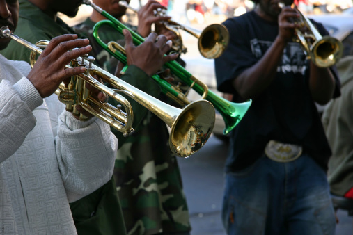 Trumpet players play all that jazz on New York City street corner (shallow depth of field).