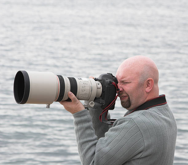 istock photographer with telescopic lens 175602873