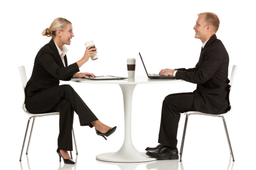 Business executives sitting across from one another at a table