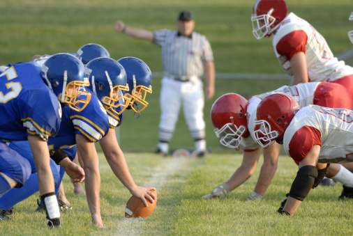 American high school football focusing on the line of scrimmage.