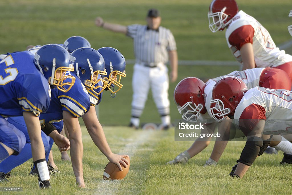 Football Game line of scrimage American high school football focusing on the line of scrimmage. American Football - Sport Stock Photo