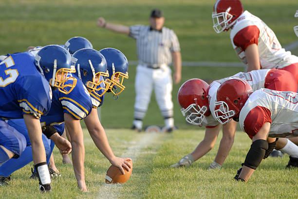 Football Game line of scrimage American high school football focusing on the line of scrimmage. offense sporting position photos stock pictures, royalty-free photos & images