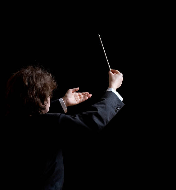 Musical Conductor Conductor's hands with a baton musical conductor stock pictures, royalty-free photos & images