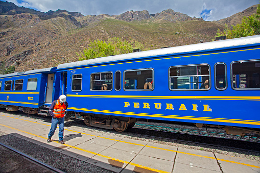 CUSCO, PERU - May 3, 2022: PeruRail train wagon on railway in peruvian forest landscape of scenic Altiplano mountain on way to latin tourist attraction Machu Picchu, Aguas Calientes