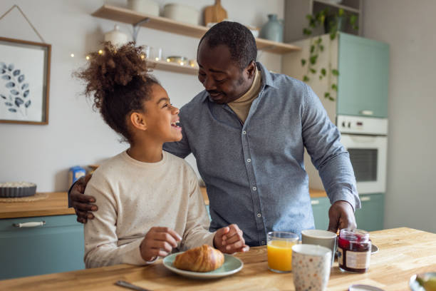 istock Father and daughter having breakfast at home 1756040037