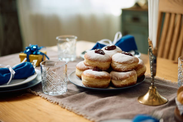 istock Traditional jam filled donuts on dining table during Hanukkah. 1756043046