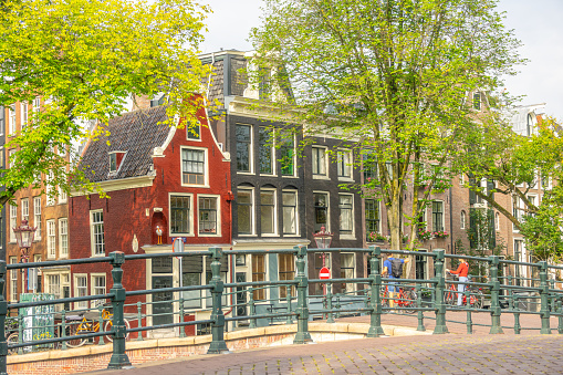 Netherlands. Facades of typical buildings on the summer embankment of the Amsterdam Canal. Sunny day