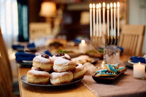 istock Traditional Jewish donut on dining table during Hanukkah celebration. 1756059993