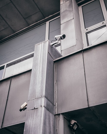A metallic structure with multiple CCTV cameras attached to its side, providing security surveillance