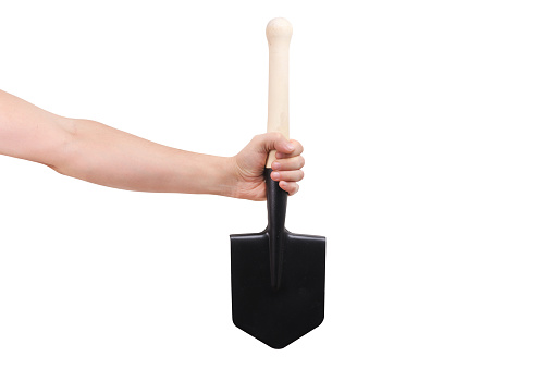 A hand holds a sapper shovel on a white background.