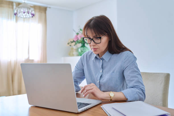 istock Middle aged business woman working on computer in home office 1756075207