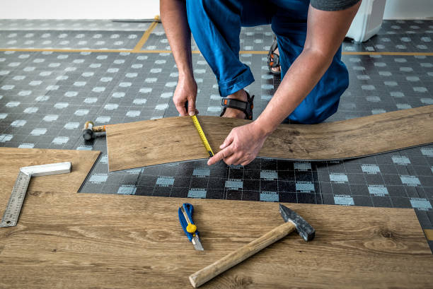 istock Worker joining vinyl floor covering at home renovation. DIY tools 1756085914