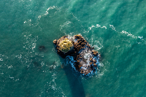 An Aerial View of a Small Rocky Outcrop Island With a Grassy Top in the Pacific Ocean off the Coast of Chile