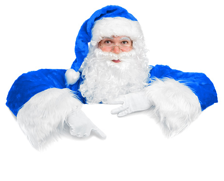 Blue dressed Christmas Santa peeking out of a white blank sign, showing something by his index finger. Isolated on white. You can add extra white space with your Christmas message to the bottom.