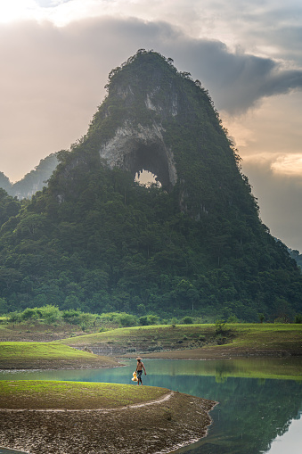 view of fishermen fishing on river in Thung mountain in Tra Linh, Cao Bang province, Vietnam with lake, cloudy, nature. Travel and landscape concept.