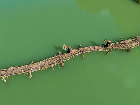 Aerial landscape in Phong Nam valley, farmers carry rice home at Cao Bang province, Vietnam with river, nature, green rice fields. Travel and landscape concept.