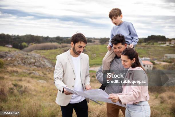 Real Estate Agent Showing Family Allotment To Build Their New Home Stock Photo - Download Image Now