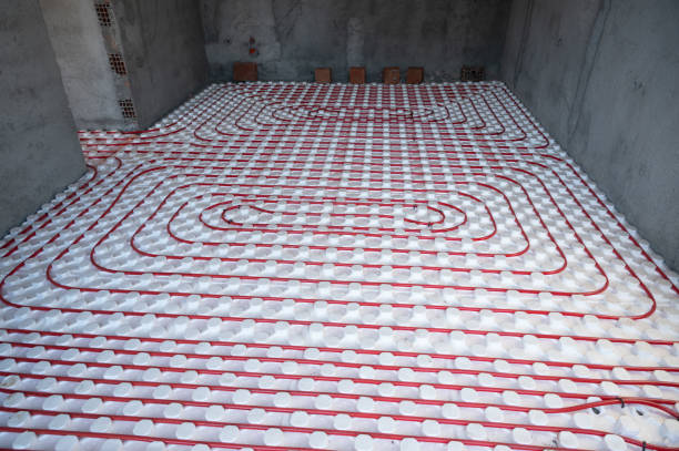 Water heating pipe on the floor at new apartment stock photo