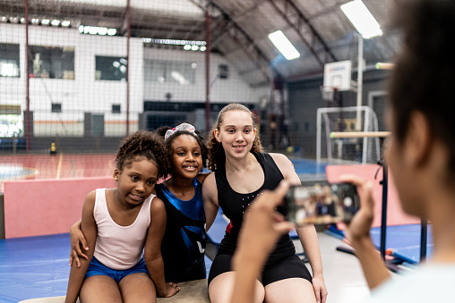 Girls being photographed on the mobile phone in a gymnasium