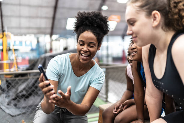 istock Athletes and coach using mobile phone in a gymnasium 1756156563